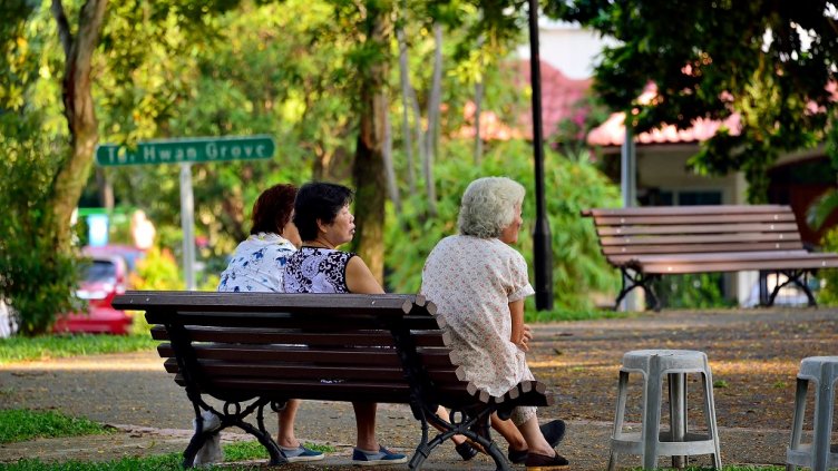 Singapore - May 12th 2018: A group of elderly Chinese ladies sitting and relaxing on a bench in a park in Serangoon Gardens with soft early morning light; Shutterstock ID 1089334580; Departmental Cost Code : 162800; Project Code: GBLMKT; PO Number: GBLMKT; Other: 