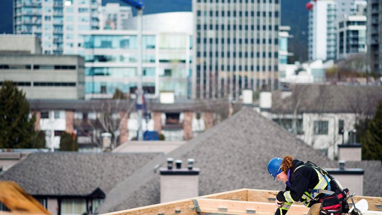 A worker uses a tape measure on one of the top floors of the Adera Development Corp. Crest mass-timber construction site in North Vancouver, British Columbia, Canada, on Tuesday, Feb. 11, 2020. Across Canada, there are plans to build more wood highrises, as the federal building code is set to allow wooden buildings of up to 12 stories, when it's revised later this year, CBC reports. Photographer: James MacDonald/Bloomberg via Getty Images