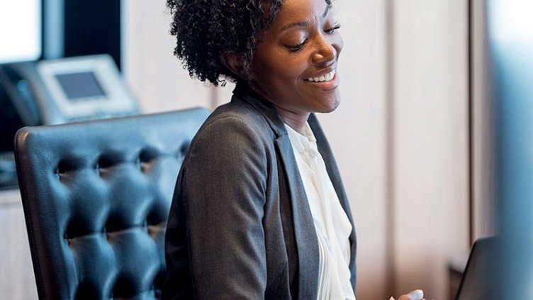 Woman having video call with her team members and smiling in the conversation